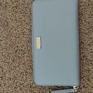 Gray zippered around Kate Spade wallet